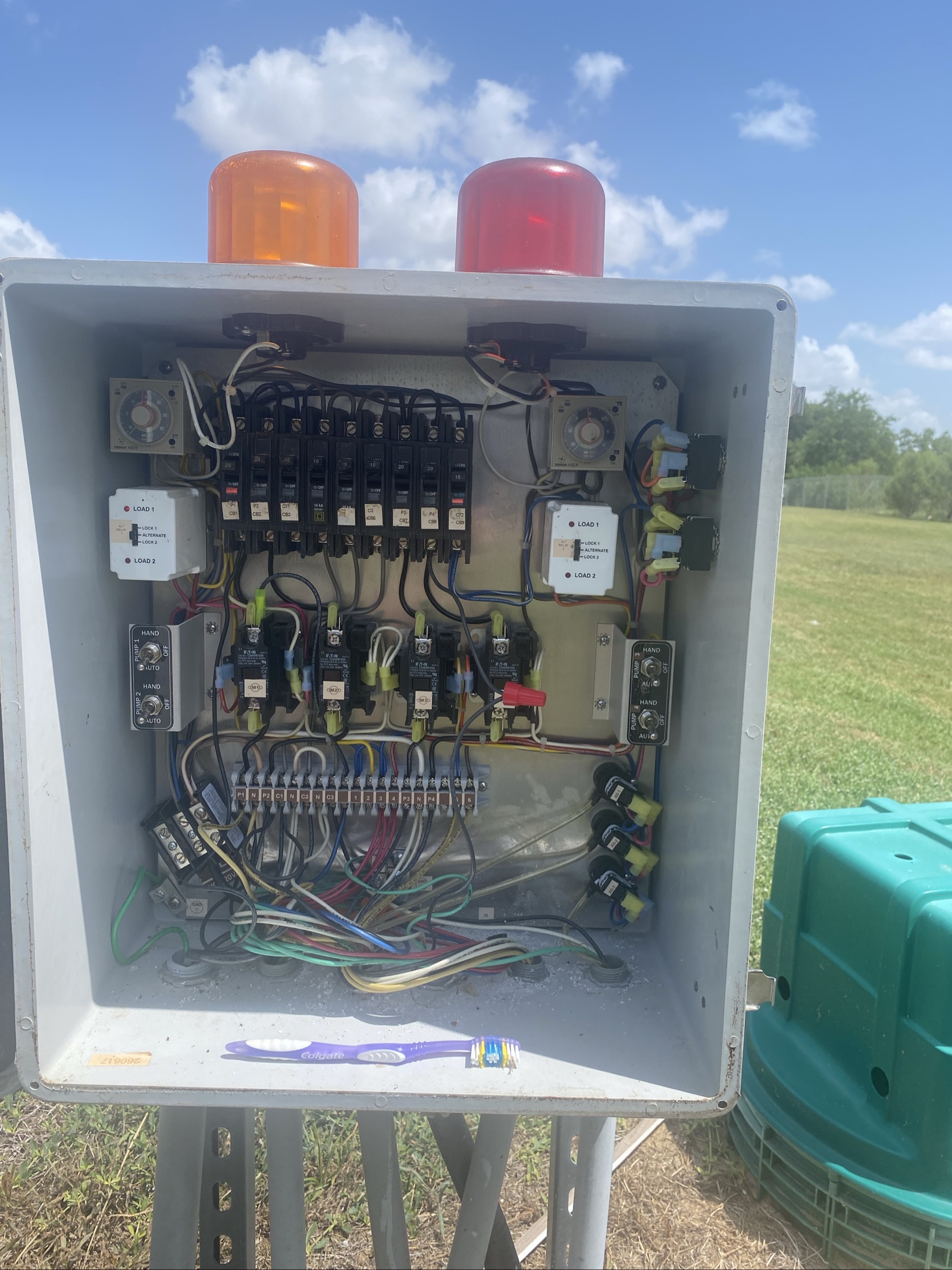 Aerobic treatment unit control panel with relays and alarm wiring being serviced