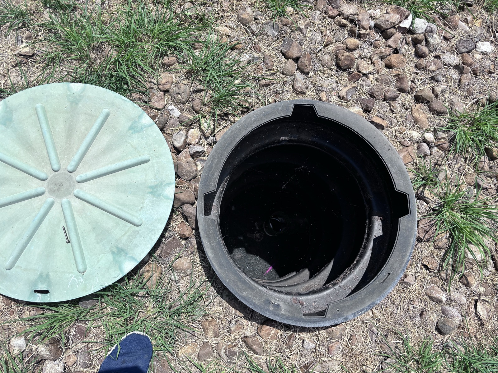 Aerobic treatment unit access lid removed for pump and float maintenance in a Florida yard
