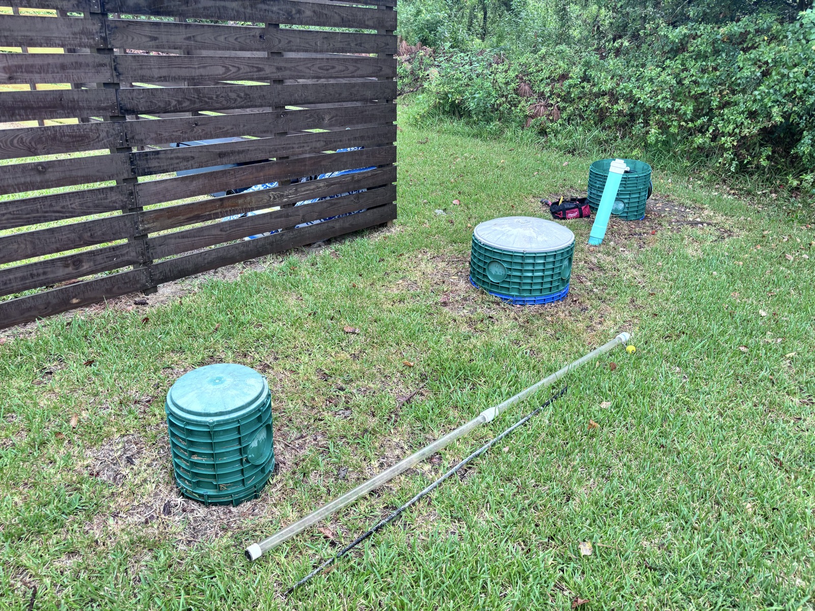 Septic system components and drainage pipes installed in residential yard during installation work