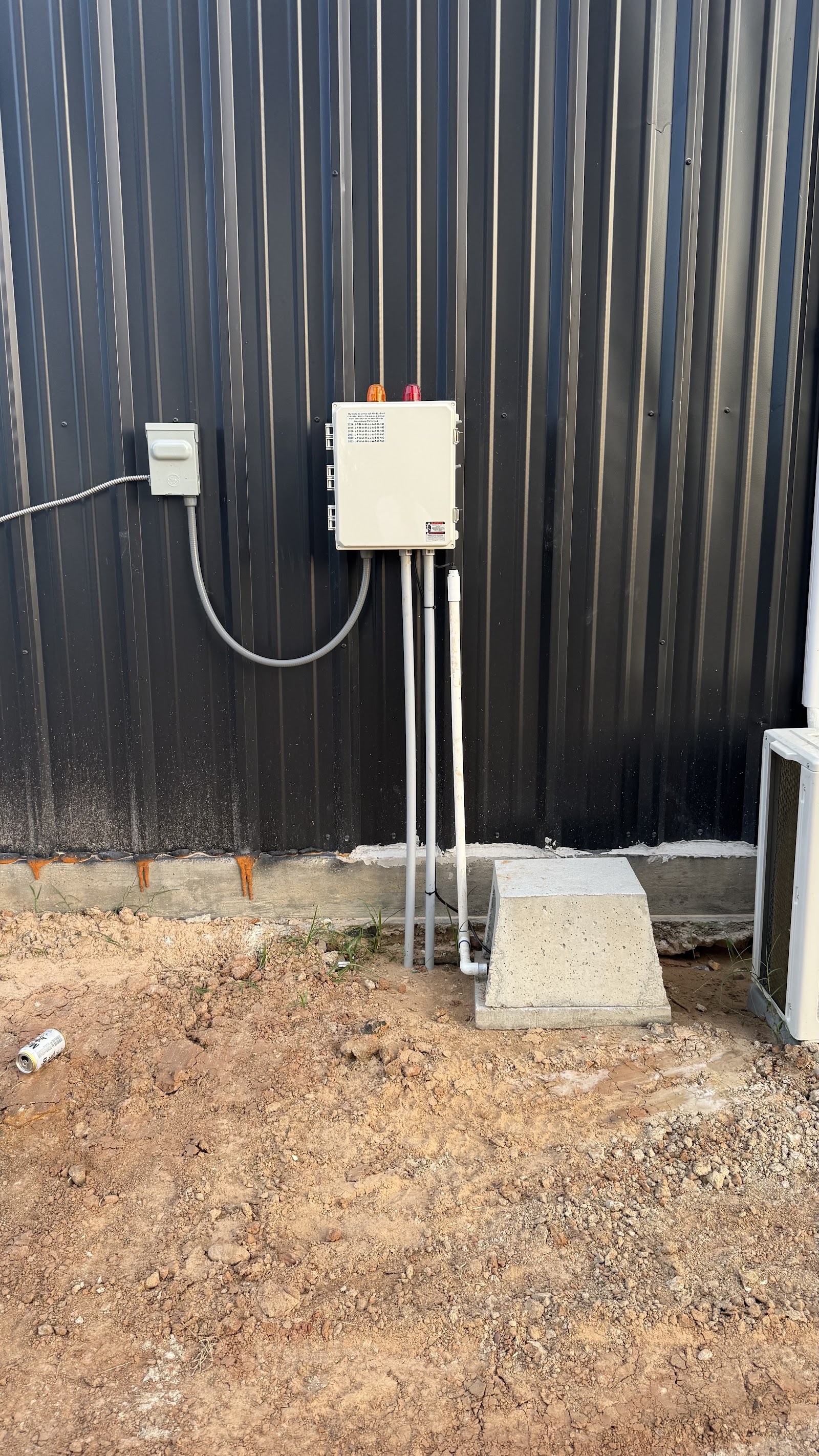 Electrical control box mounted on a dark fence